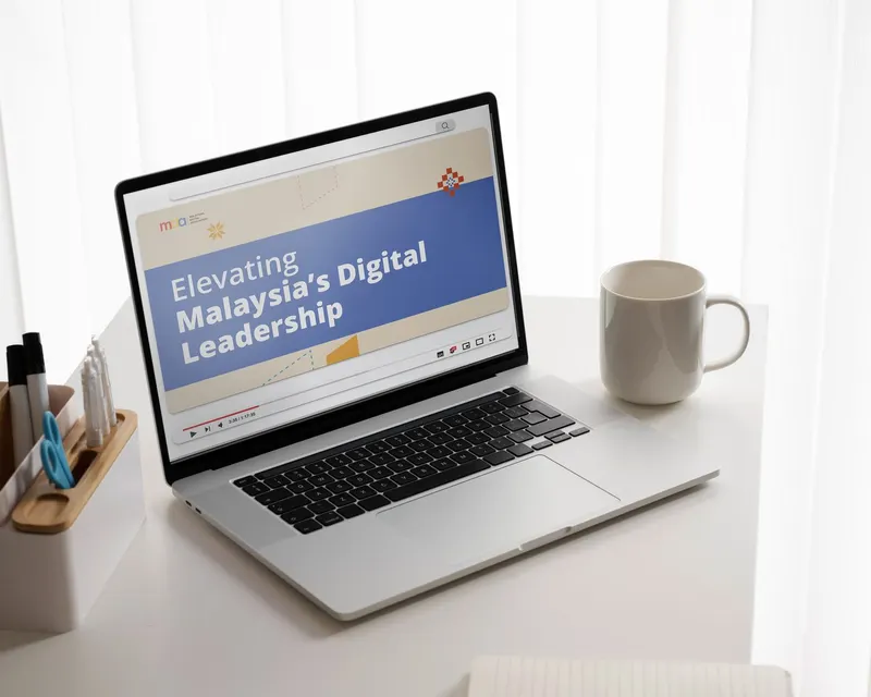 Malaysian Digital Association video title card 'Elevating Malaysia's Digital Leadership' on a laptop screen